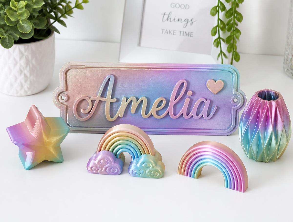 Pastel 3D-printed decorations including a personalised name plaque and rainbows